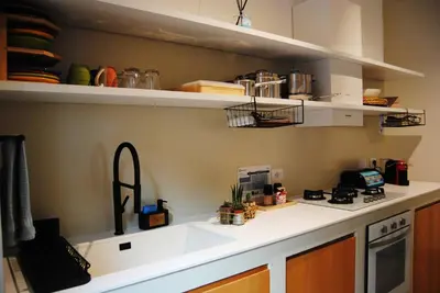 a kitchen with a sink and a counter top at Alloggio Appio Claudio con Corte Esclusiva I Metro A in Rome