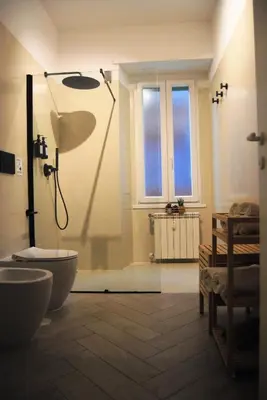 a bathroom with a shower and a toilet at Alloggio Appio Claudio con Corte Esclusiva I Metro A in Rome