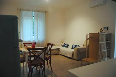 a living room with a couch and a table and chairs at Alloggio Appio Claudio con Corte Esclusiva I Metro A in Rome