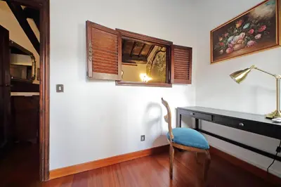 a room with a desk and a chair and a window at St.Margherita Charming House in Rome
