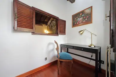 a desk with a lamp and a chair in a room at St.Margherita Charming House in Rome
