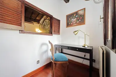 a desk with a chair and a lamp in a room at St.Margherita Charming House in Rome