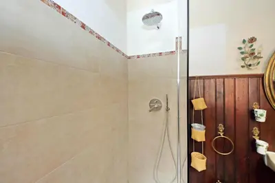 a shower with a glass door in a bathroom at St.Margherita Charming House in Rome