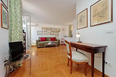 a living room with a desk and a tv and a couch at Lovely Apartment Via Sistina in Rome