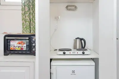 a kitchen with a microwave and a stove at Lovely Apartment Via Sistina in Rome