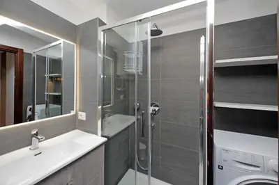 a bathroom with a sink and a shower at Lovely Apartment Via Sistina in Rome