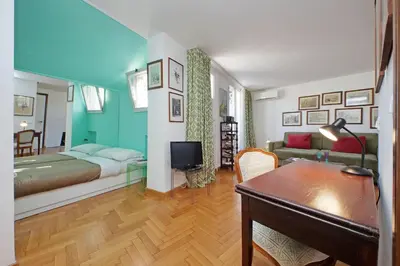 a bedroom with a bed and a desk in a room at Lovely Apartment Via Sistina in Rome