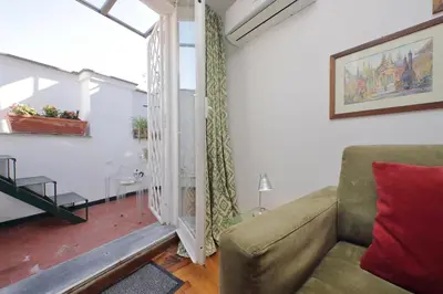a living room with a couch and a window at Lovely Apartment Via Sistina in Rome