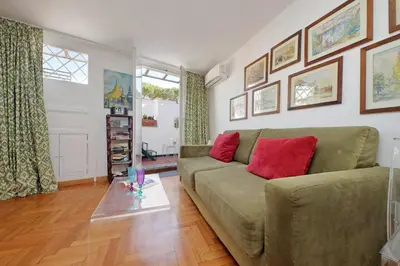 a living room with a green couch and red pillows at Lovely Apartment Via Sistina in Rome