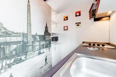 a kitchen with a sink and a picture of a city at Romantic house with terrace in Rome