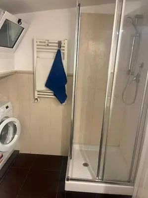 a shower with a glass door in a bathroom at Notte tra le stelle in Rome
