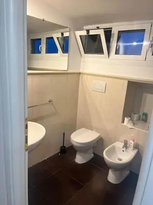 a small bathroom with a toilet and a sink at Notte tra le stelle in Rome