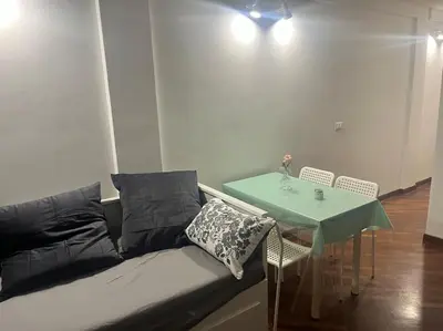 a black couch with a green table and chairs at Notte tra le stelle in Rome