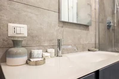 a bathroom sink with a vase sitting on top of it at Vatican Elegance House in Rome