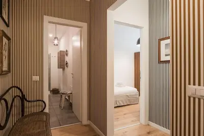 a hallway with a room with a bed and a chair at Vatican Elegance House in Rome
