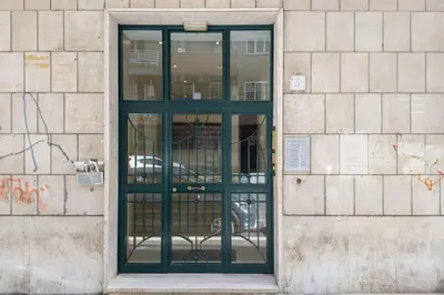 a green door on a brick building at Vatican Elegance House in Rome