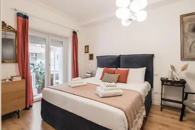 a bedroom with a large bed and a window at Vatican Elegance House in Rome