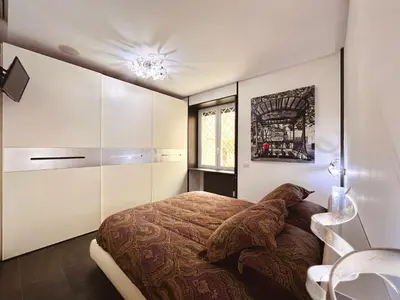 a bedroom with a bed and a sink in it at Apuania 12 in Rome