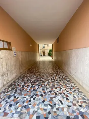 a hallway with a tiled floor in a building at Apuania 12 in Rome