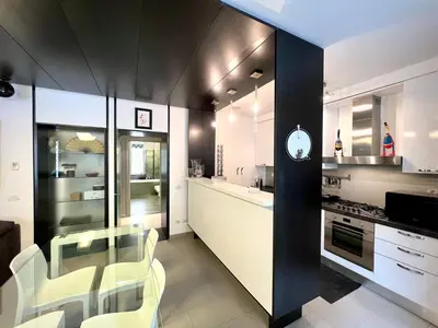 a kitchen with a glass table and white chairs at Apuania 12 in Rome