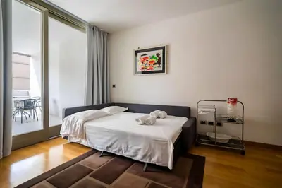 a bedroom with a bed with a teddy bear on it at 5 Min From Trastevere Rome Chic Apartment in Rome