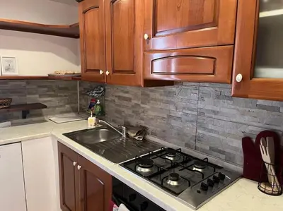 a kitchen with a stove and a sink at La Dolce Vita - Casa Mì in Rome