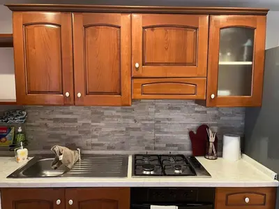 a kitchen with wooden cabinets and a stove top oven at La Dolce Vita - Casa Mì in Rome