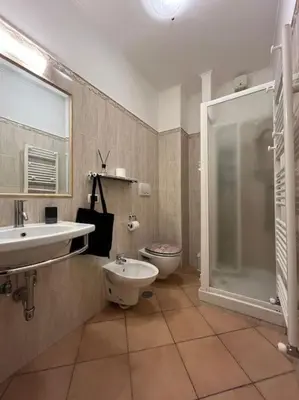 a bathroom with a toilet and a sink and a shower at La Dolce Vita - Casa Mì in Rome