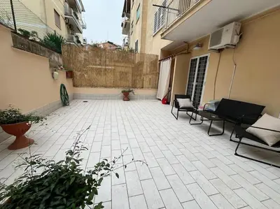 an empty courtyard with chairs and a building at La Dolce Vita - Casa Mì in Rome
