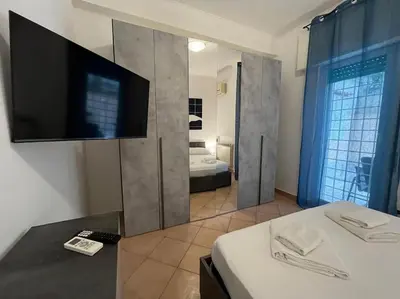 a room with a bed and a tv on a wall at La Dolce Vita - Casa Mì in Rome