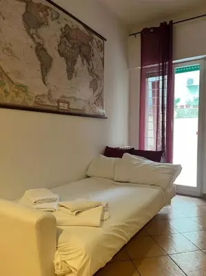 a bed in a room with a map on the wall at La Dolce Vita - Casa Mì in Rome
