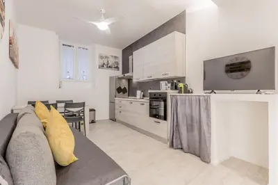 a living room with a couch and a kitchen at Casa Vaticano di Simone&Alessio in Rome