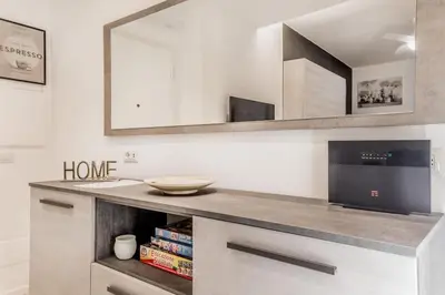 a kitchen with a counter with a sink and a mirror at Casa Vaticano di Simone&Alessio in Rome