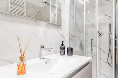 a white bathroom with a sink and a shower at Casa Vaticano di Simone&Alessio in Rome