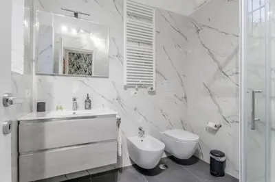 a white bathroom with a sink and a toilet at Casa Vaticano di Simone&Alessio in Rome