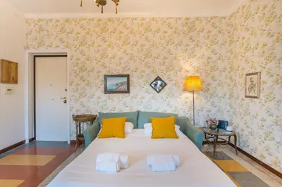a bedroom with a large white bed with yellow pillows at Casa di Alice in Rome