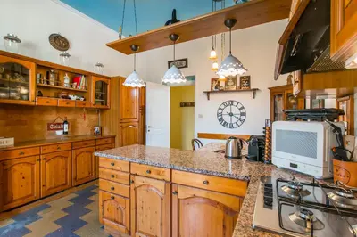a kitchen with wooden cabinets and a counter top at Casa di Alice in Rome