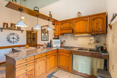 a kitchen with wooden cabinets and a counter top at Casa di Alice in Rome