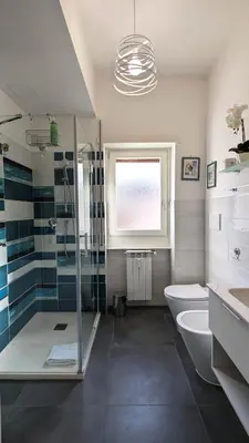 a bathroom with a shower and a toilet and a sink at Nuova Casa Elena a Montesacro in Rome