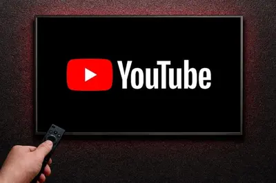 a person holding a remote control in front of a youtube sign at NEW Mini Loft per 5 a Roma centro in Rome