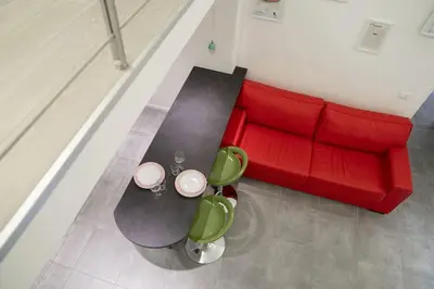an overhead view of a living room with a red couch at NEW Mini Loft per 5 a Roma centro in Rome