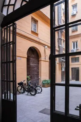 two motorcycles parked outside of a building through a window at NEW Mini Loft per 5 a Roma centro in Rome