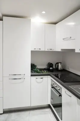 a white kitchen with white cabinets and a stove at NEW Mini Loft per 3 a Roma centro in Rome