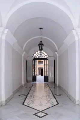 an empty hallway with a chandelier in a white building at NEW Mini Loft per 3 a Roma centro in Rome