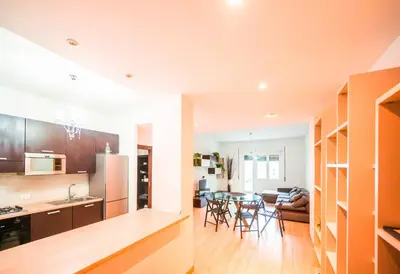 a kitchen and living room with a table and chairs at home sweet home san pietro in Rome