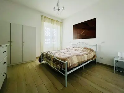 a bedroom with a bed and a dresser and a window at home sweet home san pietro in Rome