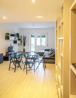 a dining room and living room with a glass table at home sweet home san pietro in Rome