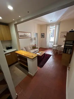 a living room with a couch and a table at Colosseum Apartment - Your Cozy Roman Escape in Rome