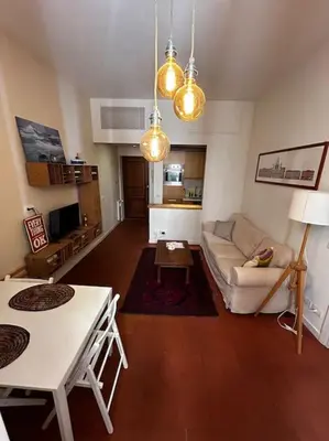 a living room with a couch and a table at Colosseum Apartment - Your Cozy Roman Escape in Rome