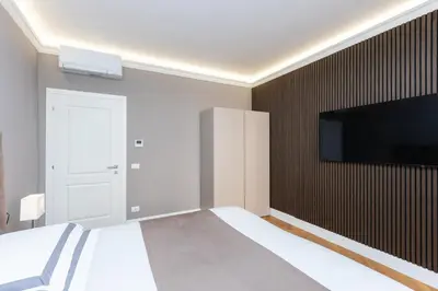 a bedroom with a bed and a flat screen tv at Amazing 3-Bedrooms Pantheon in Rome